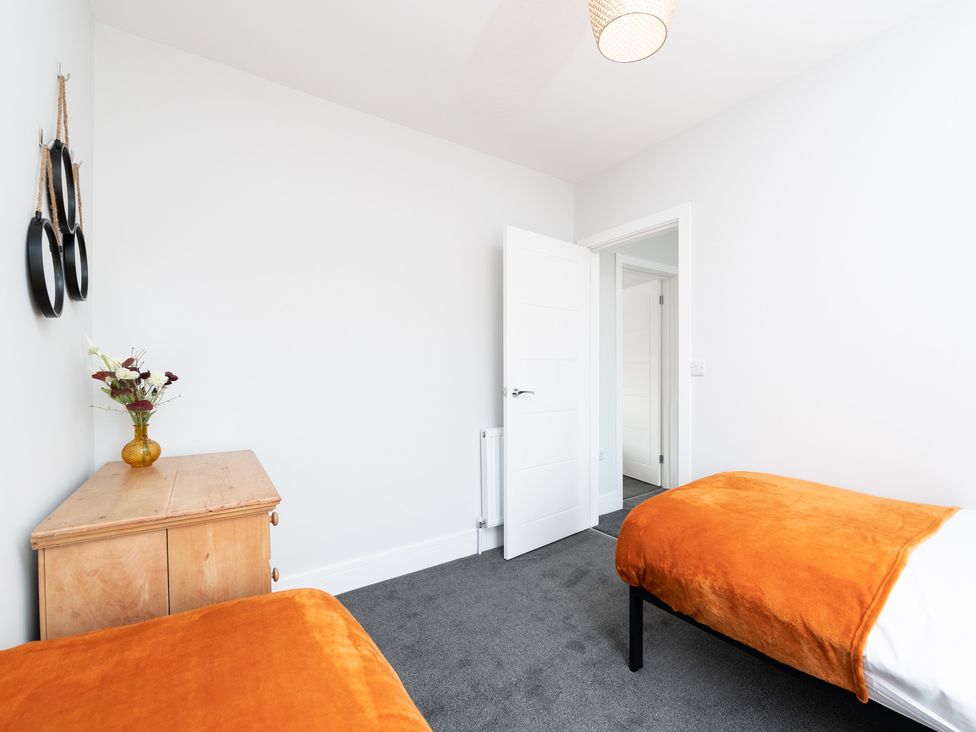 A bedroom with two beds and a dresser at 23 Trafalgar Road in Scarborough