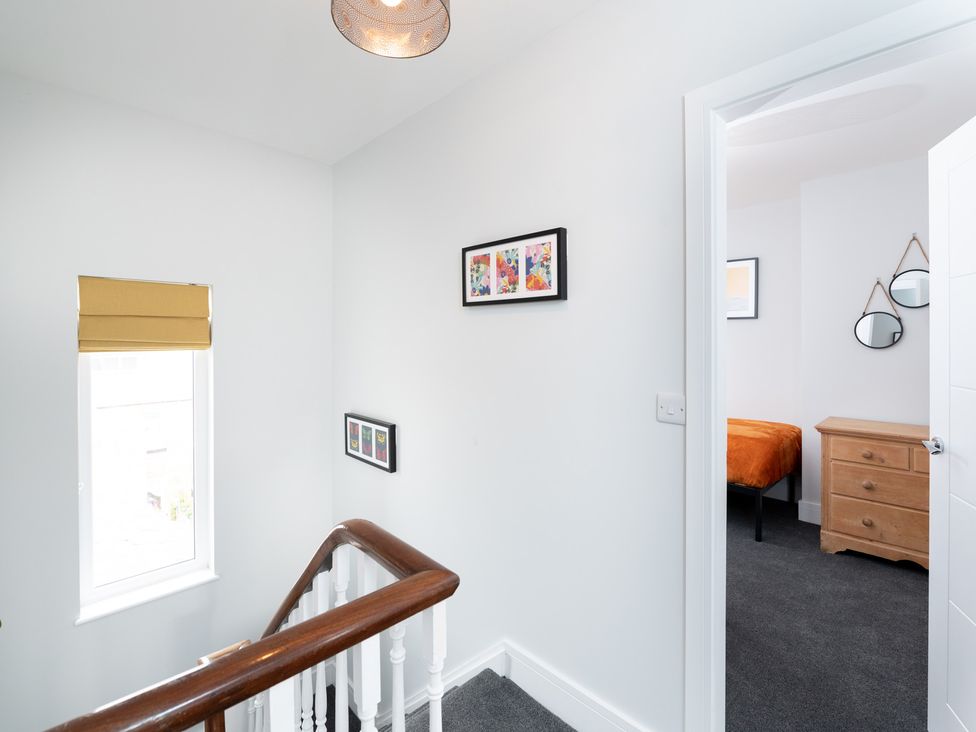 A hallway with stairs and a window at 23 Trafalgar Road in Scarborough