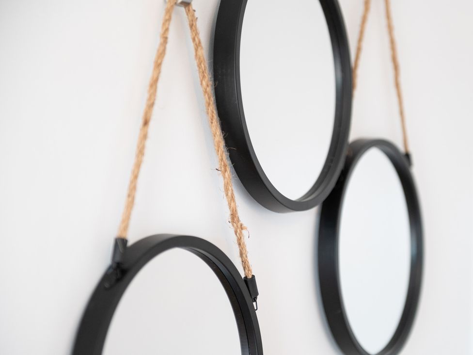 Three circular mirrors hanging with rope on a wall at 23 Trafalgar Road in Scarborough