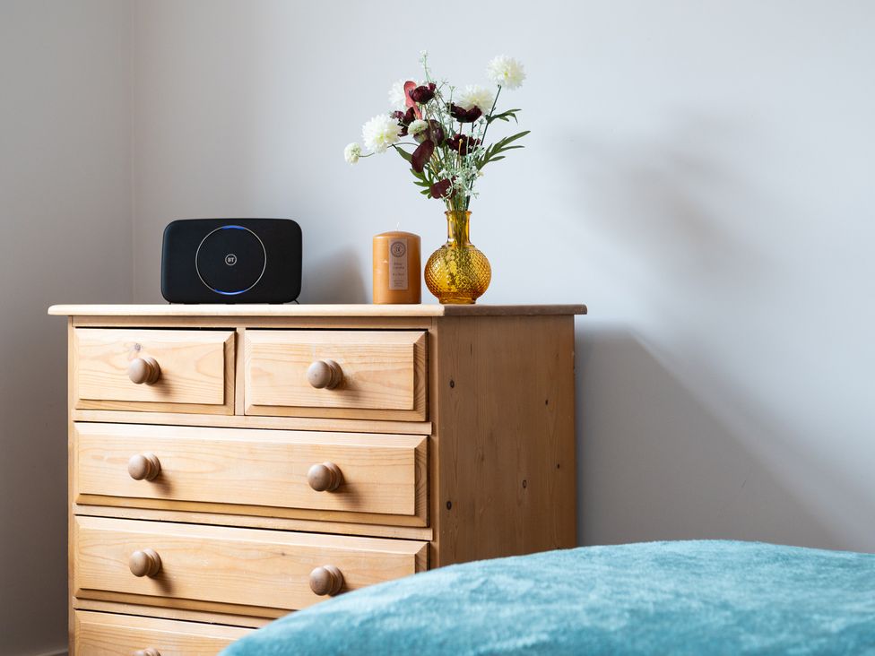 A chest of drawers with a speaker and flowers at 23 Trafalgar Road Scarborough