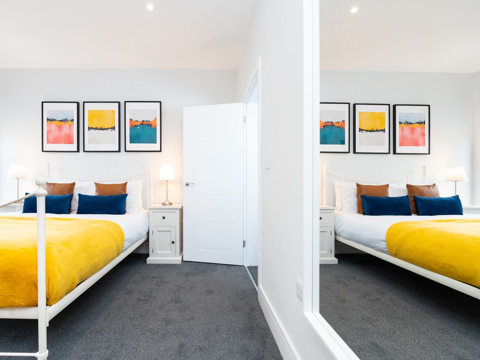 A bedroom featuring two beds and wall art at 23 Trafalgar Road in Scarborough