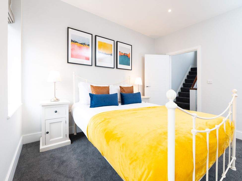 A bedroom with a bed and nightstand at 23 Trafalgar Road, Scarborough