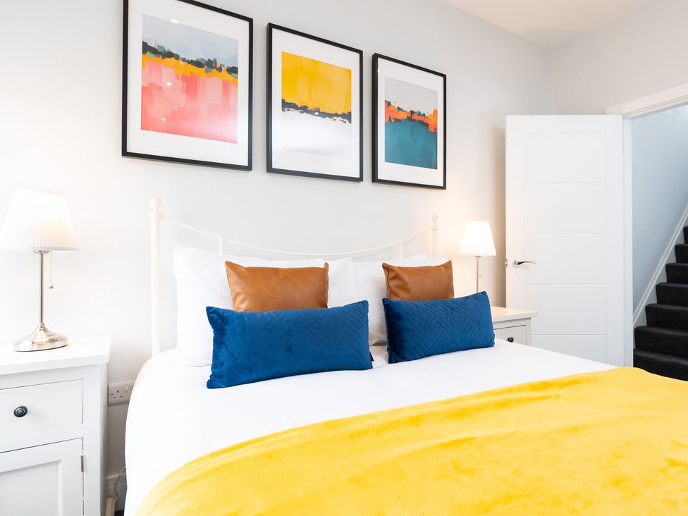 A bedroom with a bed and artwork on the wall at 23 Trafalgar Road in Scarborough