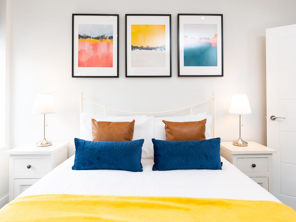 A bedroom with a bed and artwork at 23 Trafalgar Road Scarborough