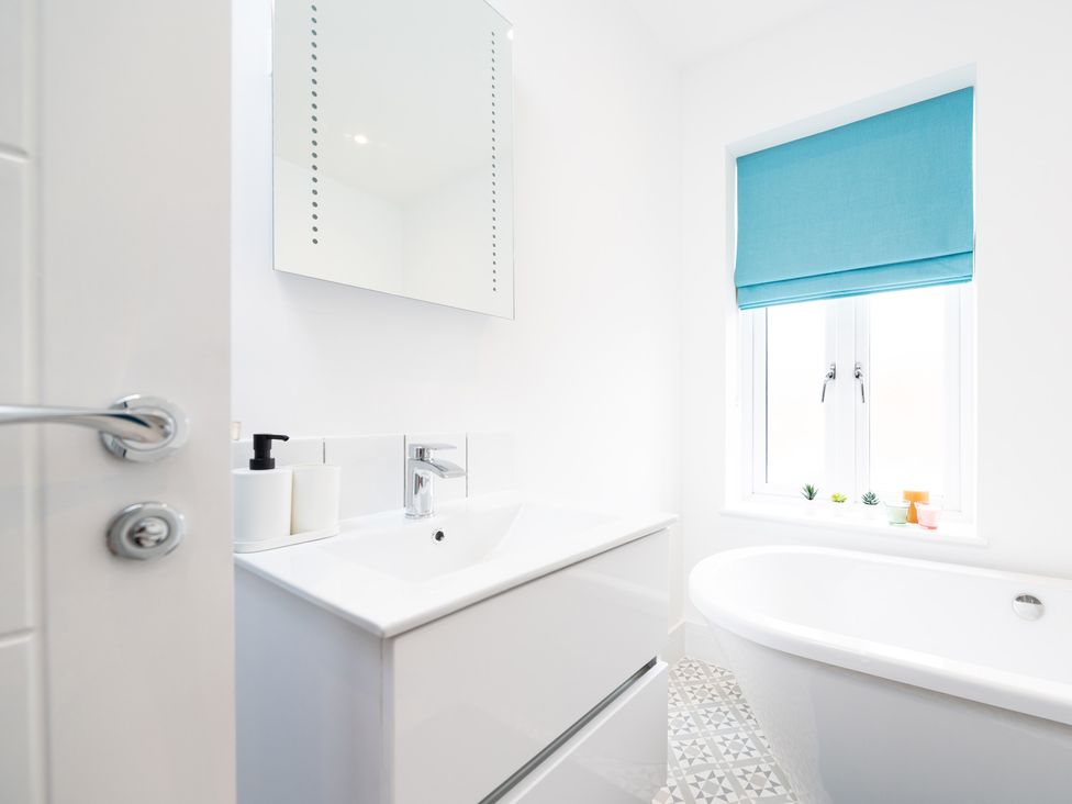 A bathroom with a bathtub and sink at 23 Trafalgar Road in Scarborough