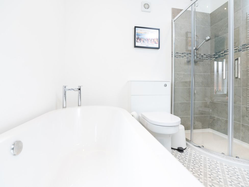 A bathroom with a bathtub, shower, and toilet at 23 Trafalgar Road, Scarborough