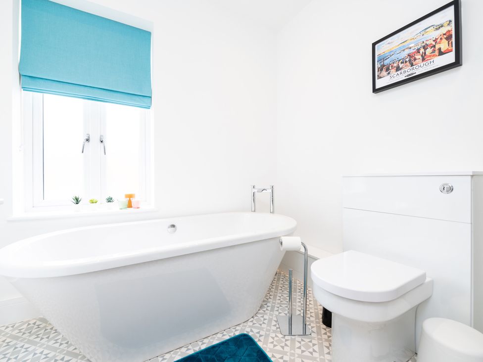 A bathroom with a bathtub and toilet at 23 Trafalgar Road in Scarborough