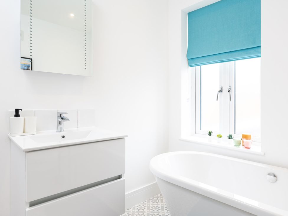 A bathroom with a bathtub and sink at 23 Trafalgar Road in Scarborough