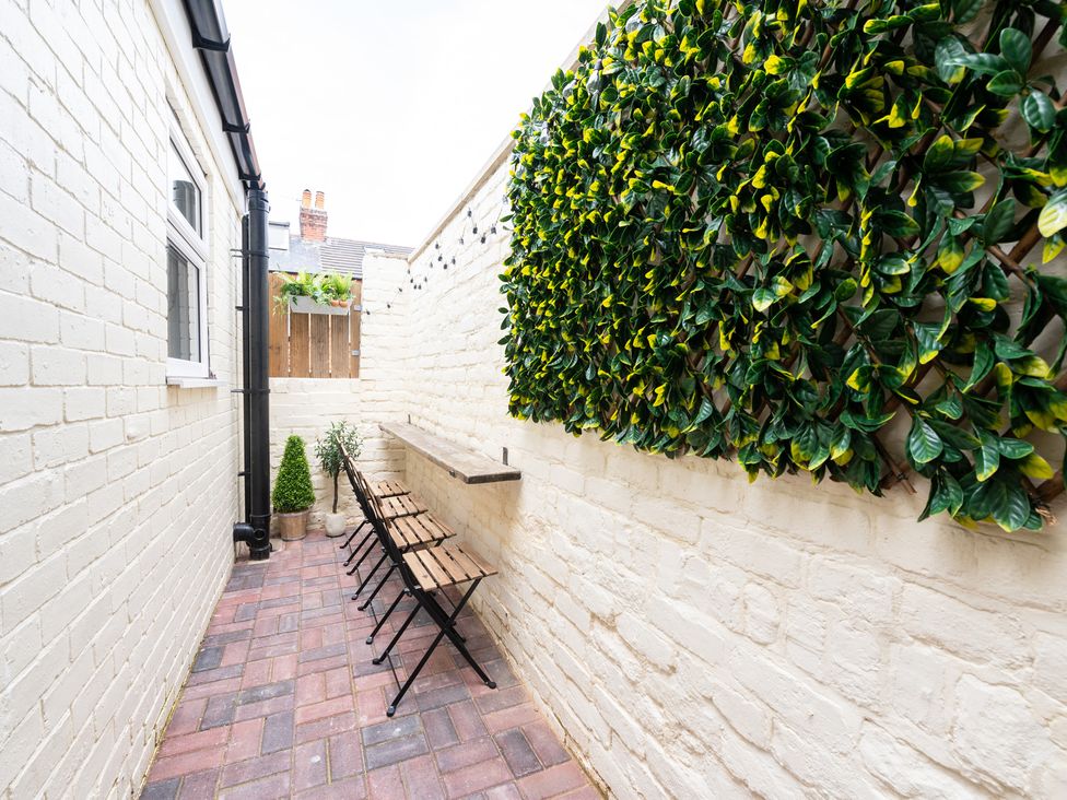 An outdoor area with a brick wall and a bench at 23 Trafalgar Road, Scarborough