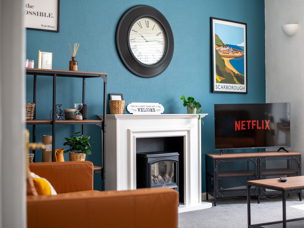 A living room with a television and clock at 53A Hampton Road Scarborough