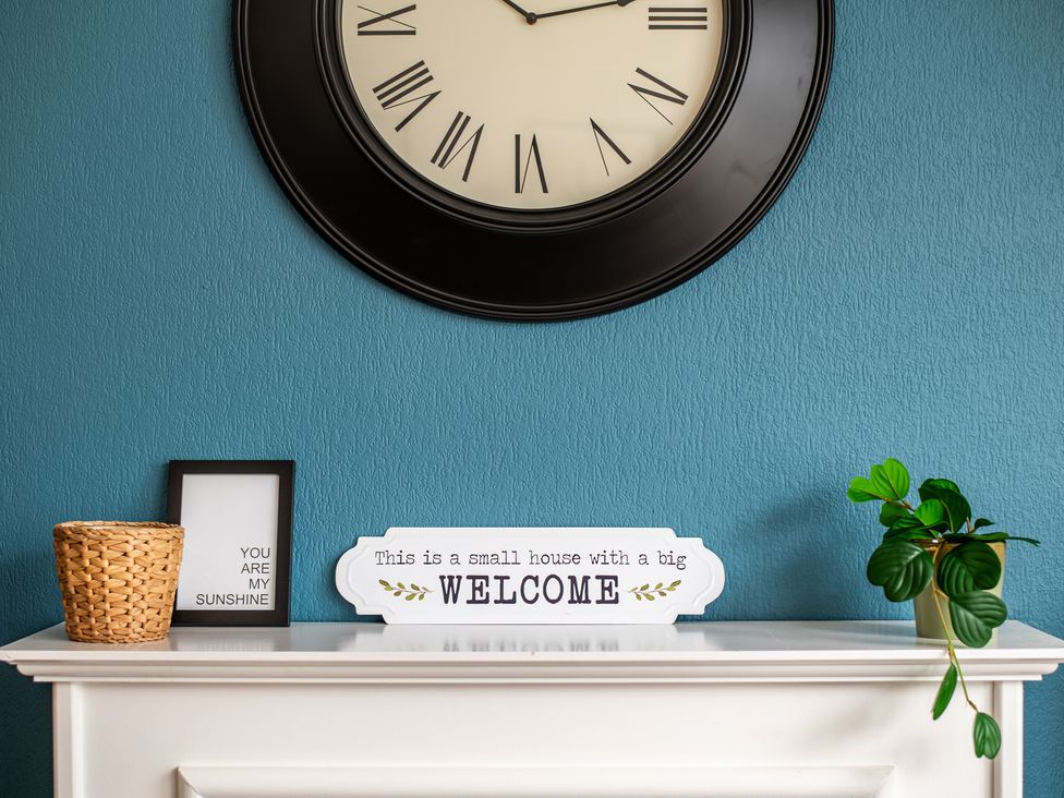 A living room with a clock and decorative items at 53A Hampton Road in Scarborough