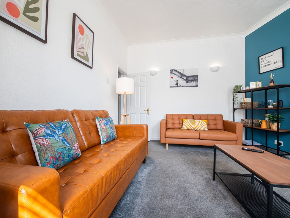 A living room with sofas and a lamp at 53A Hampton Road Scarborough