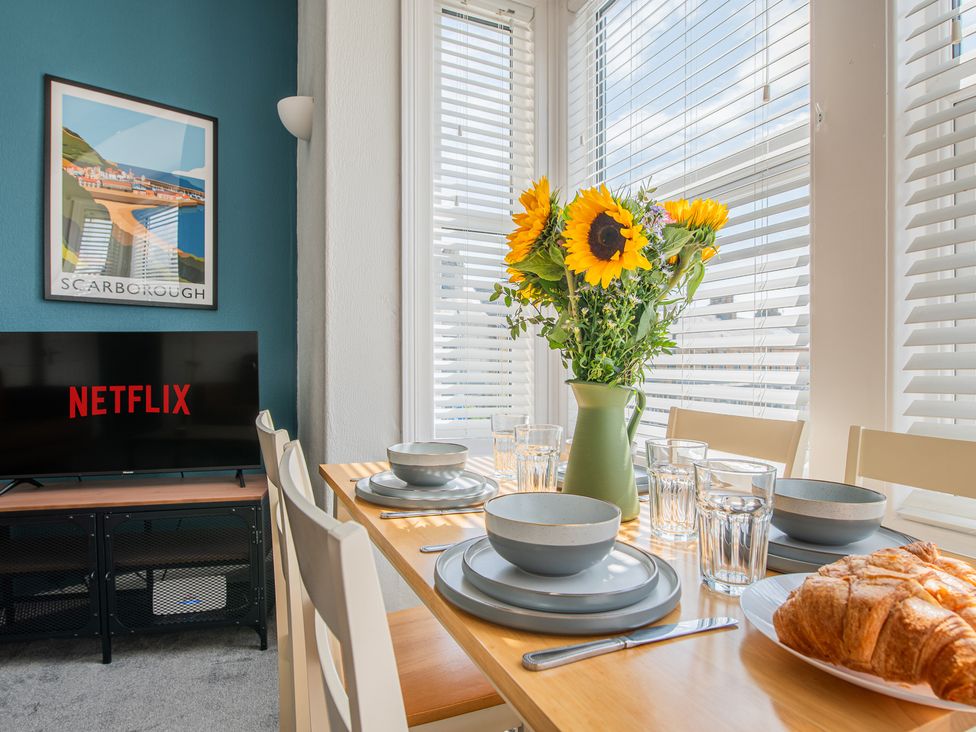 A dining room with a table set for breakfast at 53A Hampton Road, Scarborough