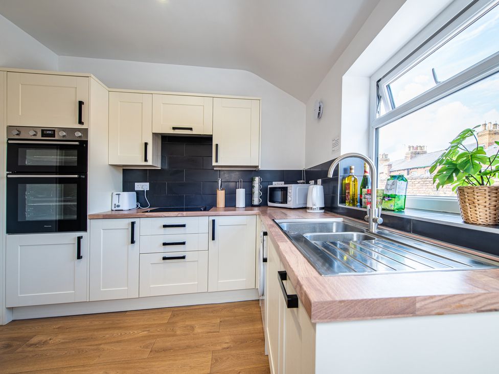 A kitchen with countertop, oven, and sink at 53A Hampton Road Scarborough