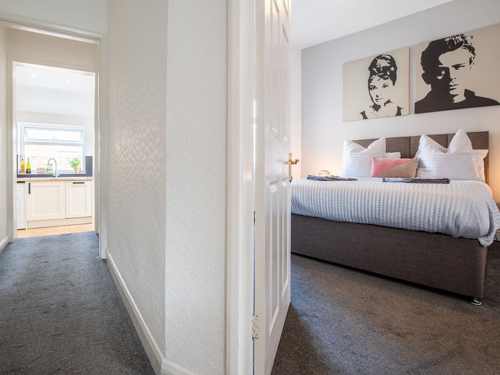 A bedroom with a bed and wall art at 53A Hampton Road Scarborough