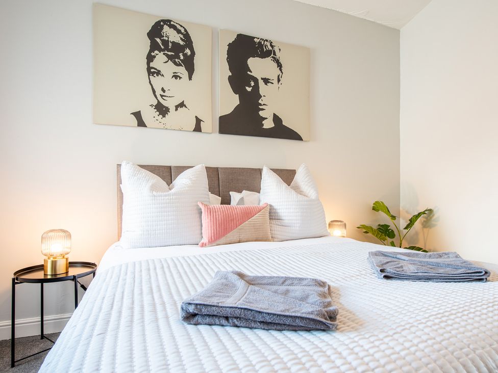 A bedroom with a bed and wall art at 53A Hampton Road Scarborough