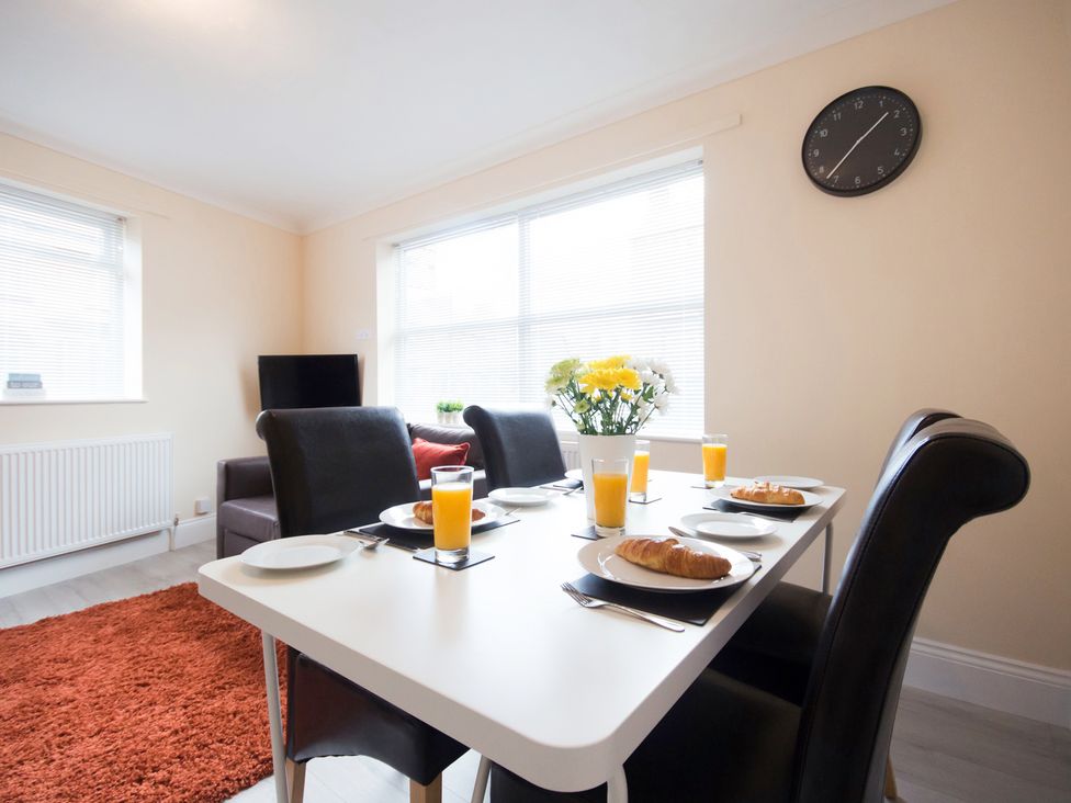 A dining room with table set for breakfast at 53 Hampton Road Scarborough