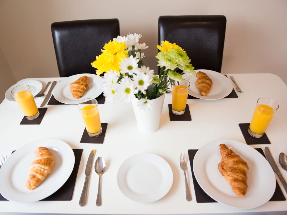 A dining table with croissants and orange juice at 53 Hampton Road Scarborough
