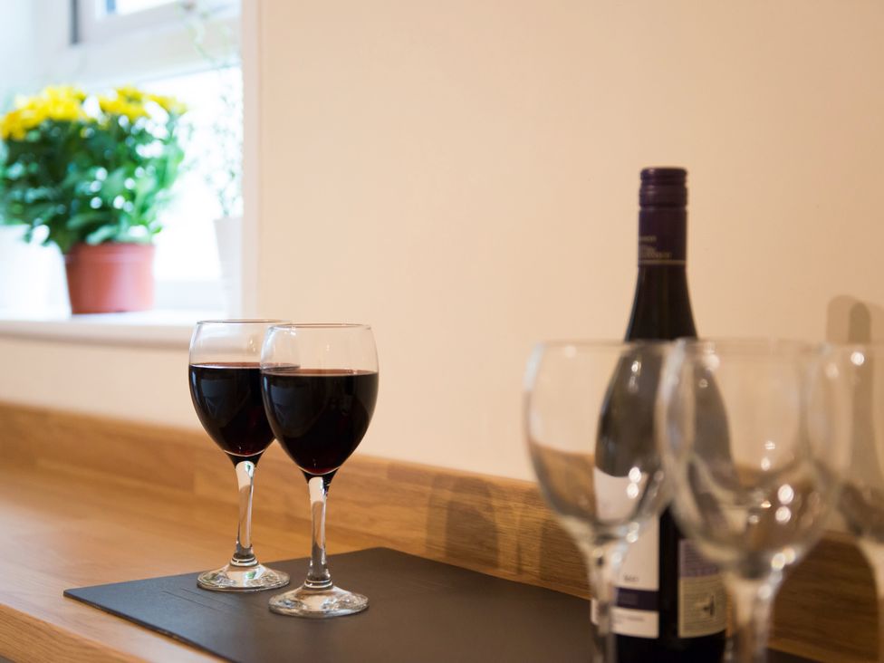 Two wine glasses and a bottle of red wine on a countertop at 53 Hampton Road Scarborough