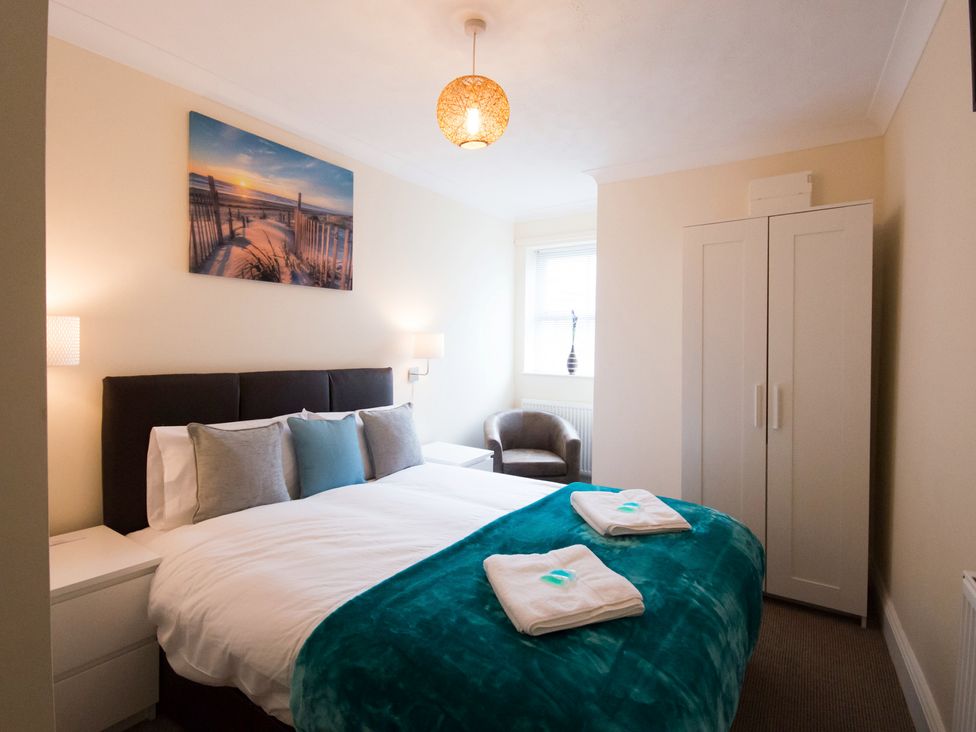 A bedroom with a bed and wardrobe at 53 Hampton Road in Scarborough
