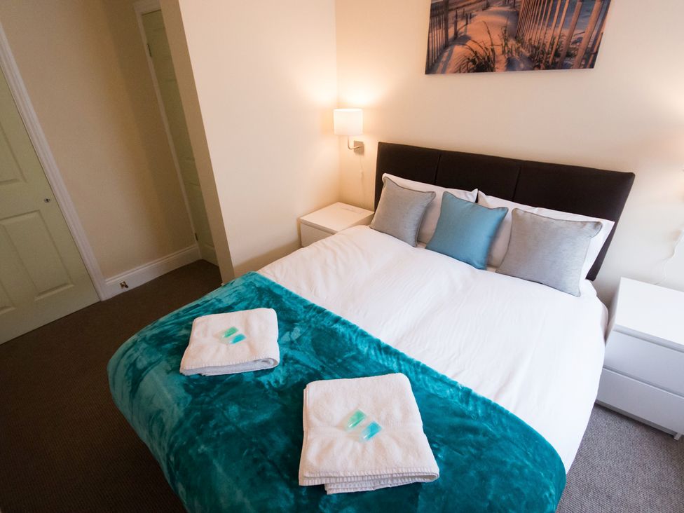 A bedroom with a bed and bedside furniture at 53 Hampton Road Scarborough