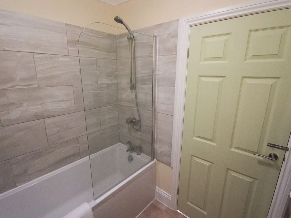 A bathroom with a bathtub and shower at 53 Hampton Road, Scarborough