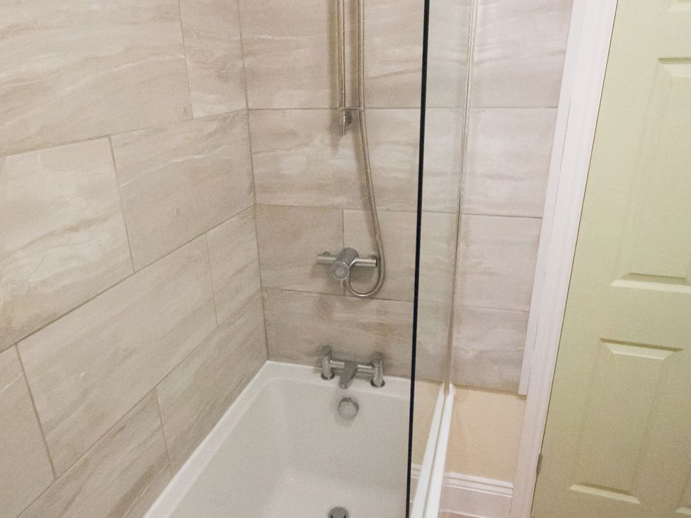 A bathtub with a shower in a bathroom at 53 Hampton Road Scarborough