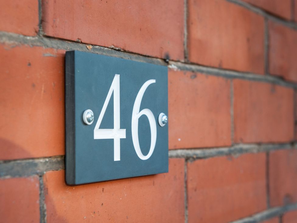 Number 46 plaque on a brick wall at 46 Ashville Avenue Scarborough