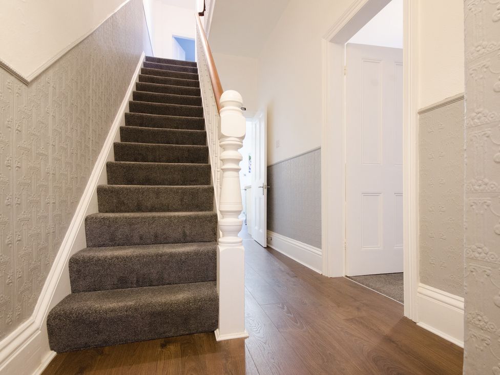 A staircase with gray carpeting in a hallway at 46 Ashville Avenue Scarborough