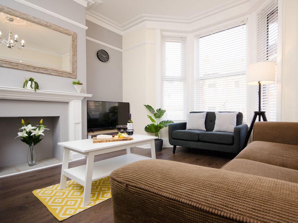A living room with a sofa and a coffee table at 46 Ashville Avenue in Scarborough