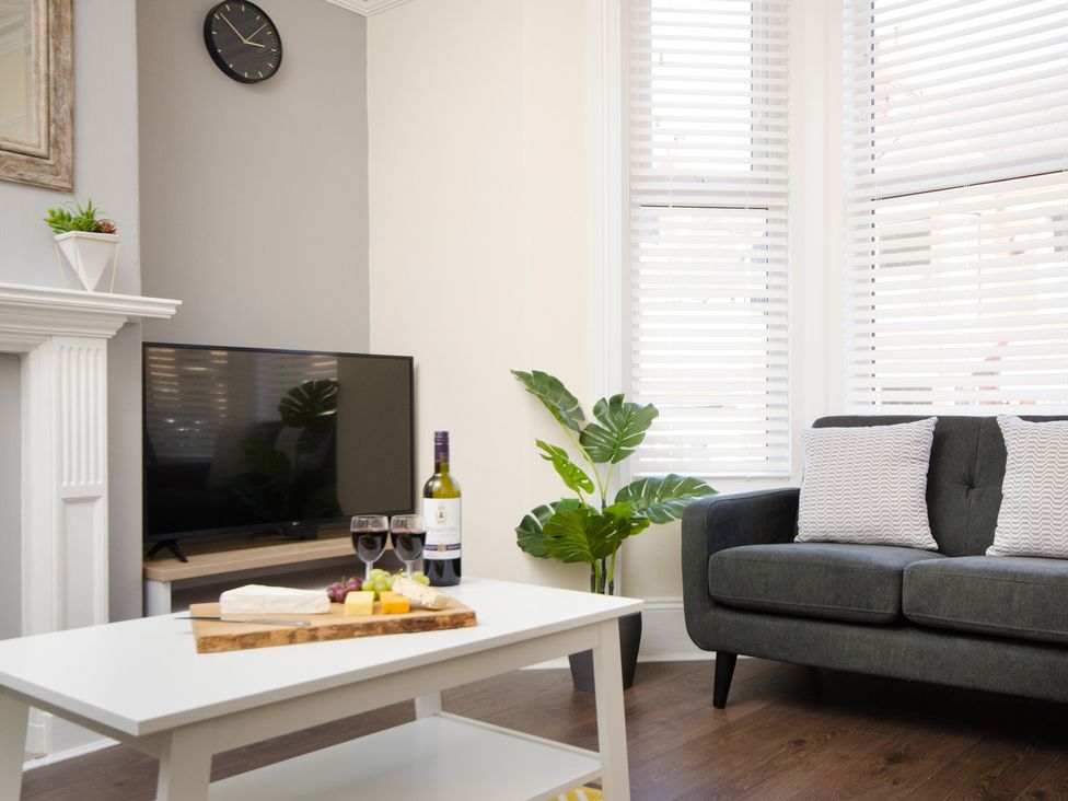 A living room with a couch and a coffee table at 46 Ashville Avenue, Scarborough