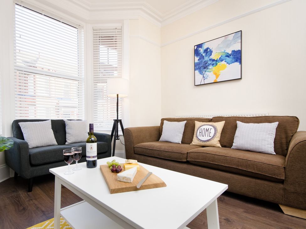 A living room with a sofa and a coffee table at 46 Ashville Avenue Scarborough