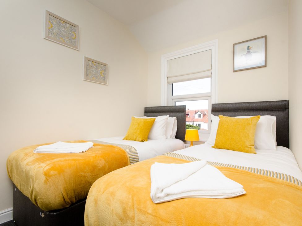 A bedroom with twin beds and a window at 46 Ashville Avenue Scarborough