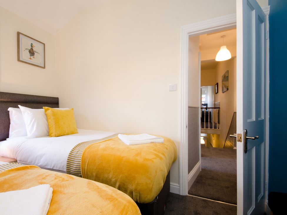 A bedroom with two beds and a view of the hallway at 46 Ashville Avenue Scarborough