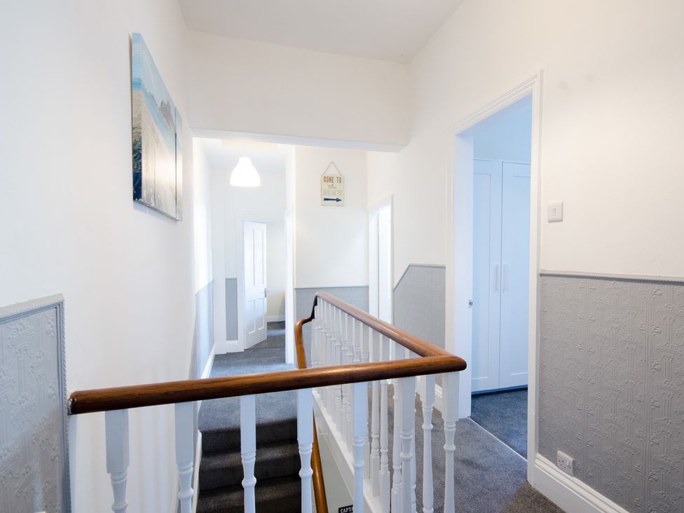 A hallway with stairs and doors at 46 Ashville Avenue in Scarborough