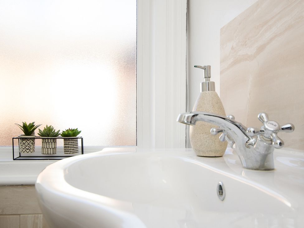 A sink with a tap and plants on a shelf at 46 Ashville Avenue Scarborough