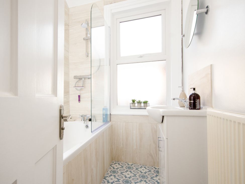 A bathroom with a bathtub and sink at 46 Ashville Avenue in Scarborough