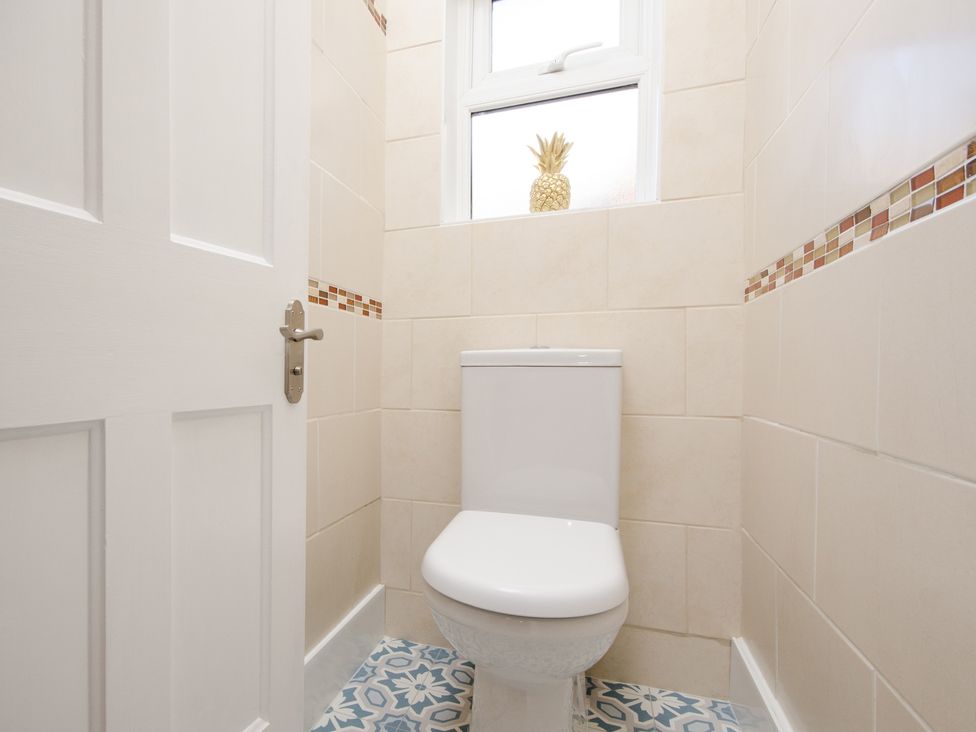 A bathroom featuring a toilet and a window at 46 Ashville Avenue, Scarborough