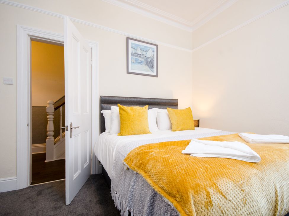 A bedroom with a bed and staircase at 46 Ashville Avenue Scarborough