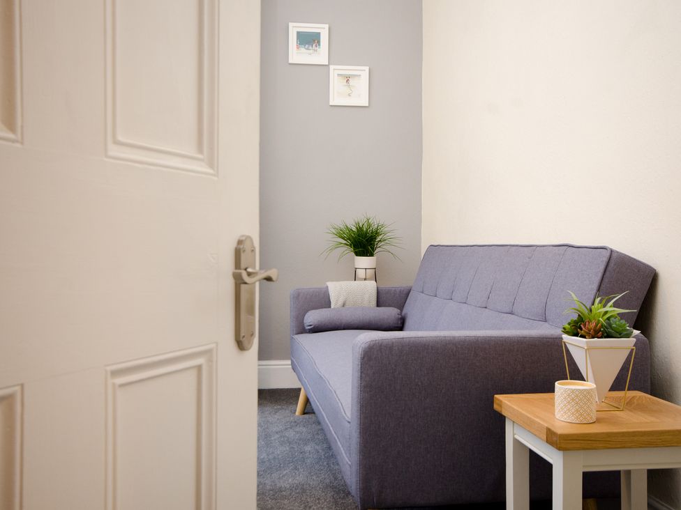 A snug with a sofa and a table at 46 Ashville Avenue Scarborough