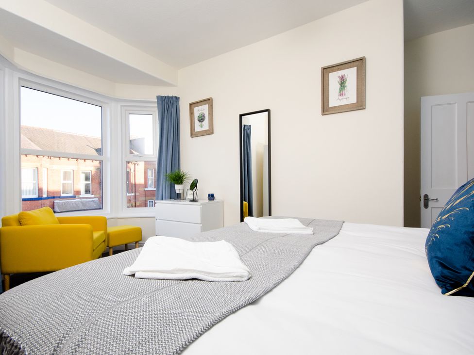 A bedroom with a bed and a mirror at 46 Ashville Avenue in Scarborough