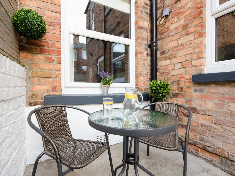An outdoor seating area with a table and chairs at 46 Ashville Avenue, Scarborough