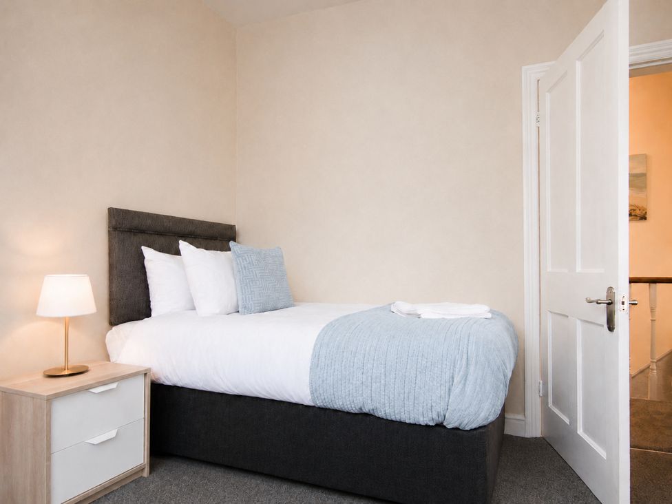 A bedroom with a bed and bedside table at 46 Ashville Avenue Scarborough