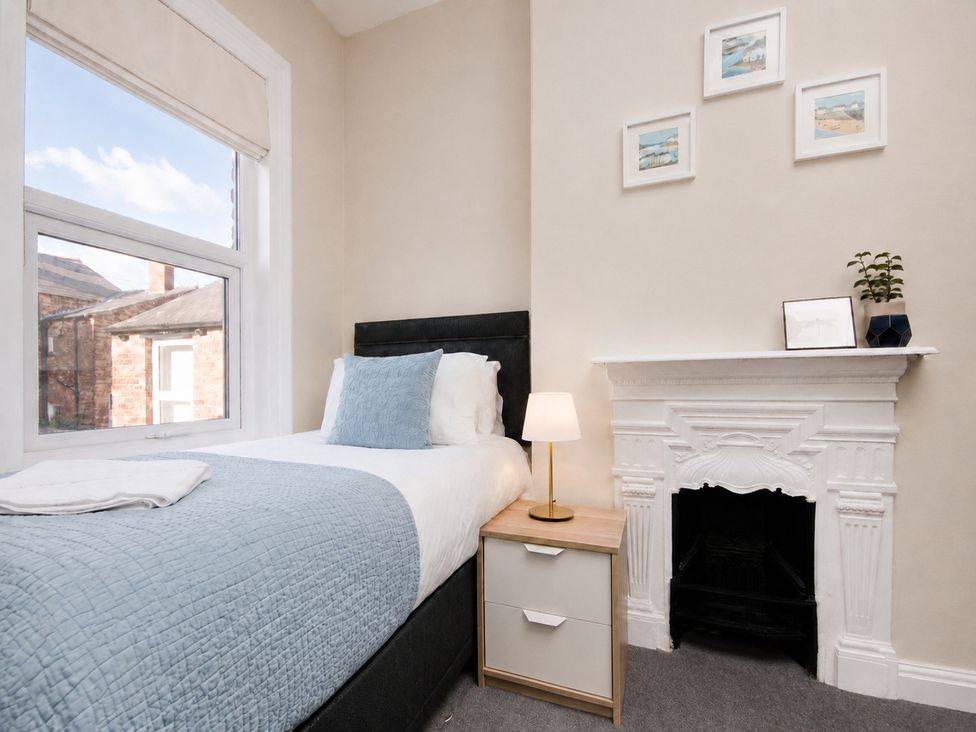 A bedroom with a bed and nightstand at 46 Ashville Avenue, Scarborough