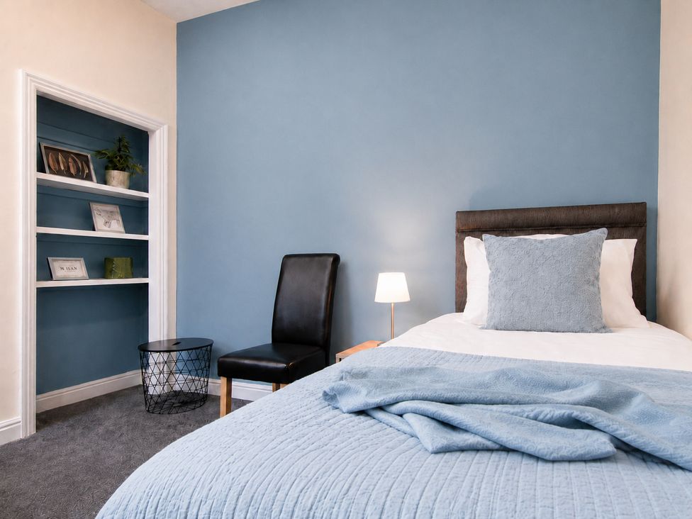 A bedroom with a bed and chair at 46 Ashville Avenue, Scarborough