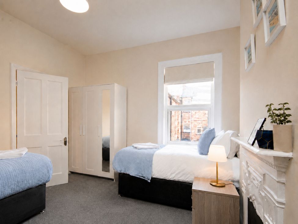 A bedroom with two beds and a wardrobe at 46 Ashville Avenue Scarborough
