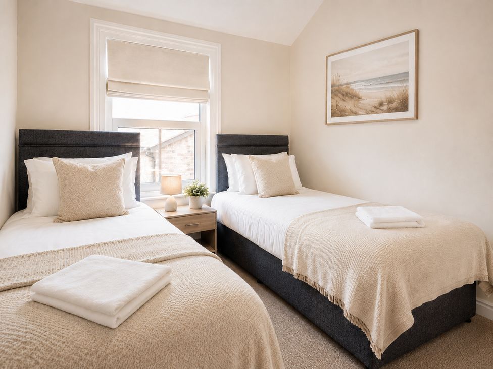 A bedroom with two beds and a painting at 46 Ashville Avenue Scarborough