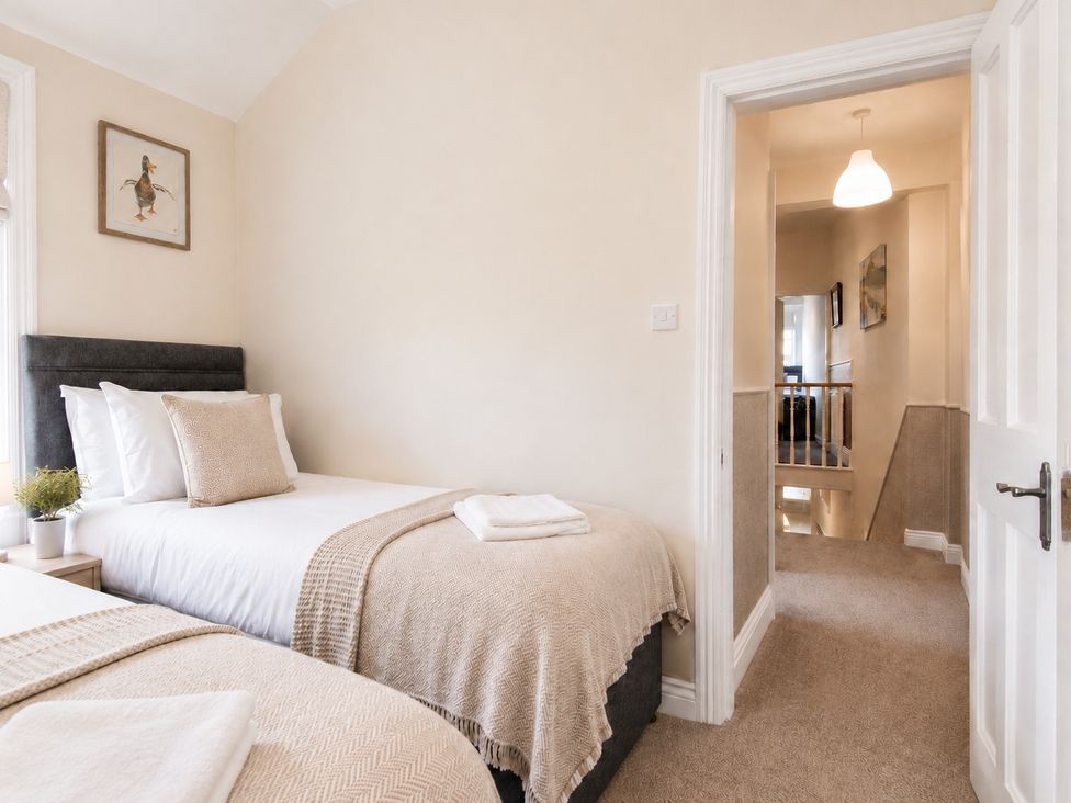 A bedroom with two beds and a plant at 46 Ashville Avenue Scarborough