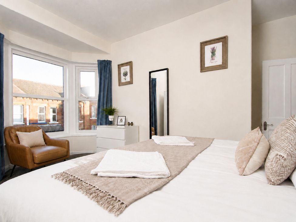 A bedroom with a bed and armchair at 46 Ashville Avenue in Scarborough