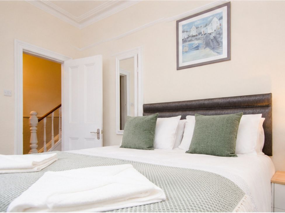A bedroom with a bed and a mirror at 46 Ashville Avenue, Scarborough
